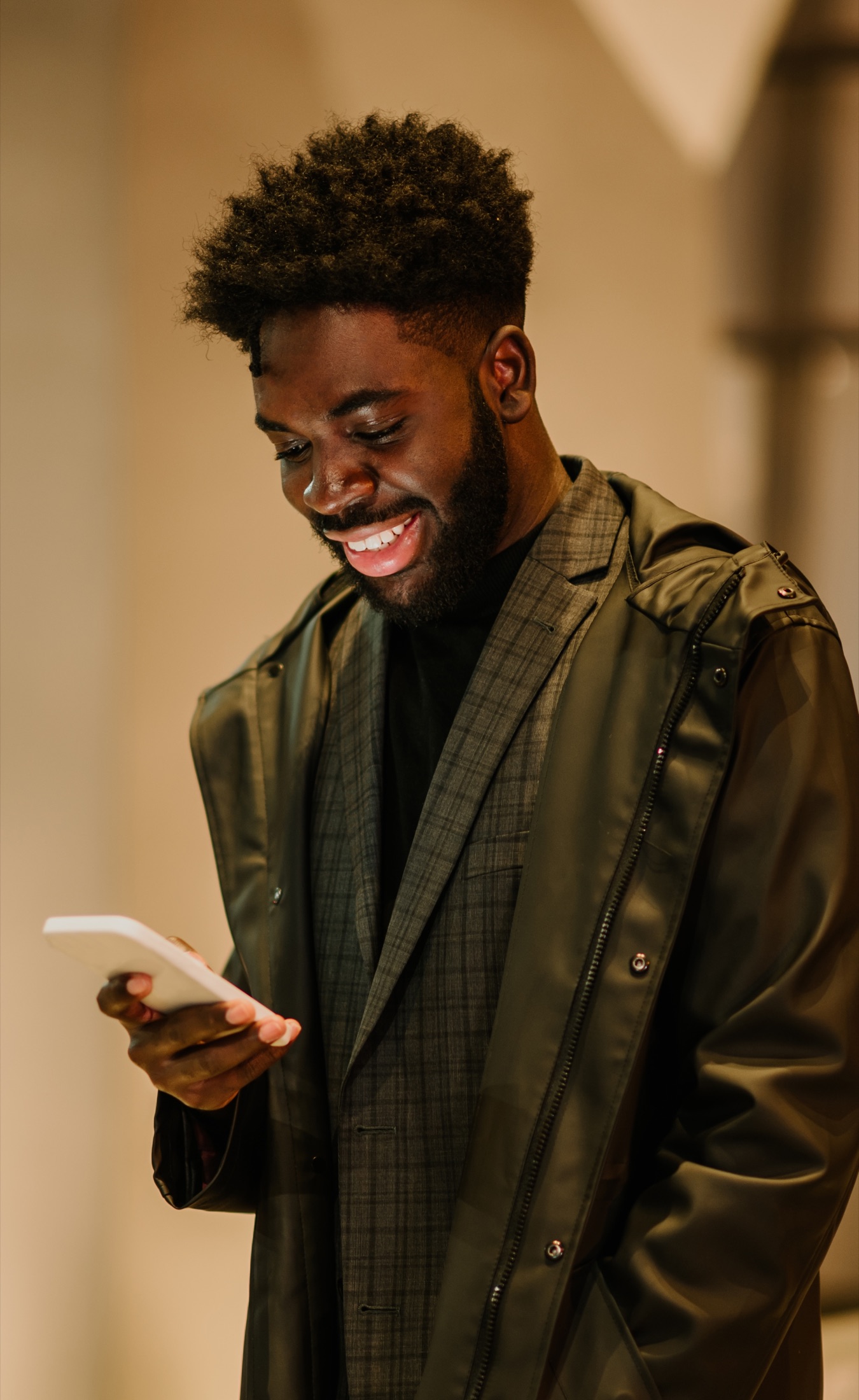 Person smiling while reading a message on a phone