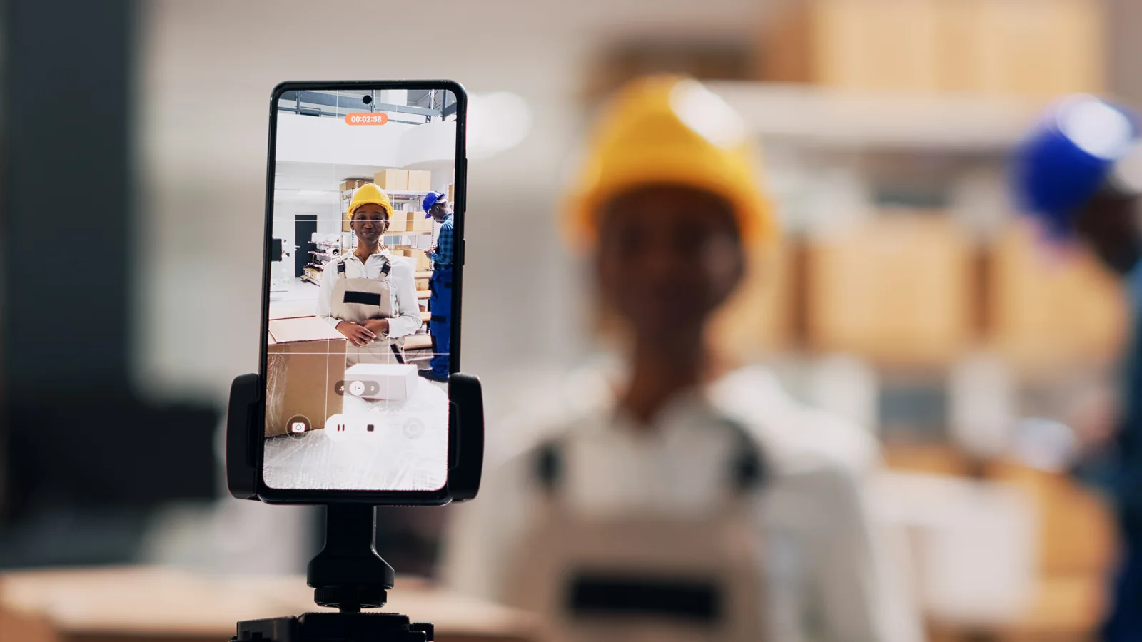 A manufacturing professional records a video at work
