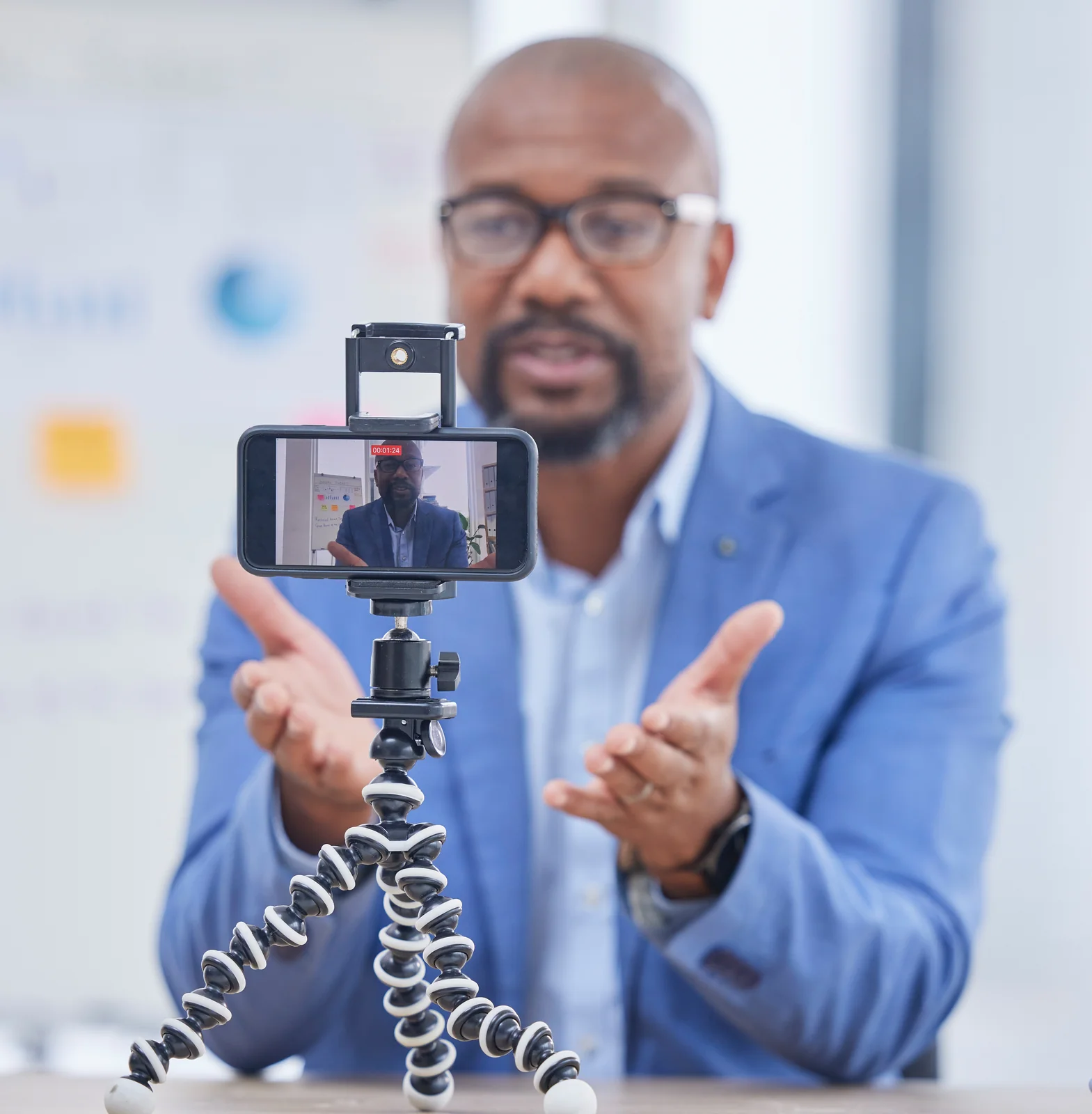 A business professional records a webinar on his phone